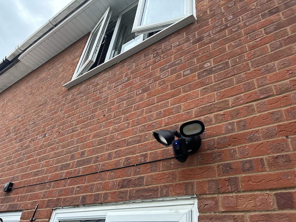 Security floodlight camera fitted to a house exterior